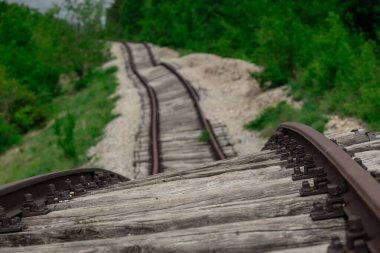 Pijana pruga or drunk railway in Istria, Croatia. A stretch of neglected railway track and bed, deformed rails, washed down by land slide or poor earth base clipart