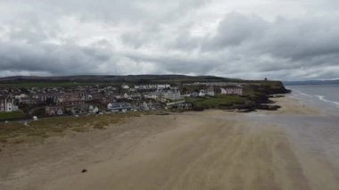 Castlerock, Kuzey İrlanda 'da, bulutlu bir bahar gününde kumlu kumsalın hava aracı manzarası. Kara bulutlar, rüzgar ve alçak gelgit Castlerock sahil kasabasında.