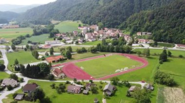 Slovenya 'nın Kozje kentindeki bir koşu pisti ve futbol stadyumunun havadan görüntüsü. Slovenia 'nın kırsal kesimindeki ya da köyündeki tipik bir stadyum.