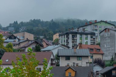 Different residental houses in Trbovlje, Slovenia, scattered on a hill. Cloudy rainy day in early autumn... clipart