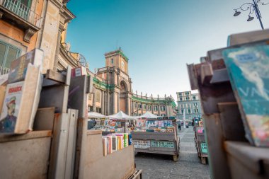 Napoli 'nin Dante Meydanı' ndaki Victorio Emanuele Manastırı 'nın önünde kullanılmış. Dante Meydanı 'nda renkli kitaplar satılıyor. Güneşli bir gün
