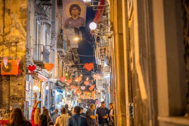 Napoli, Italy, 30.10.2024: Via dei tribunali in naples, filled with tourists and shops. Popular destination in the city.Evening setting clipart