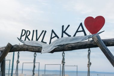 Privlaka, Croatia, 27.10.2024: Wooden sign with a heart of Privlaka village close to Zadar in dalmatian coast of croatia. clipart