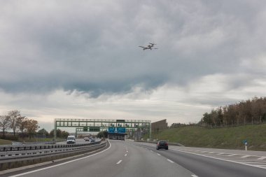 Aeroplane landing over the motorway close to Munich, germany. Small aircraft landing on Airport Oberpfaffenhofen clipart