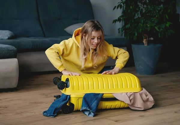 Girl Packing Yellow Suitcase Home Travel Concept — Fotografia de Stock