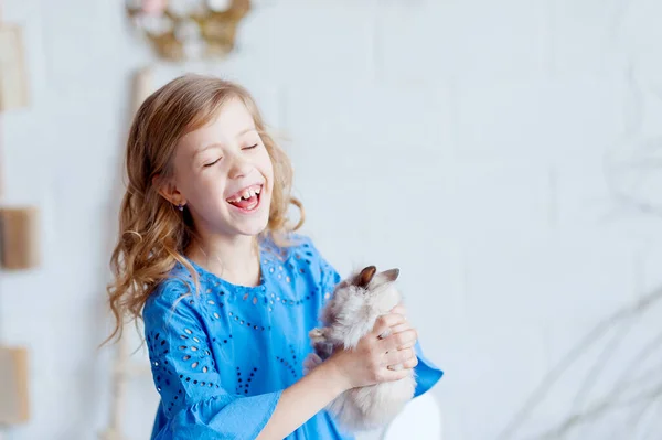 stock image Cute little girl with a bunny rabbit has a easter