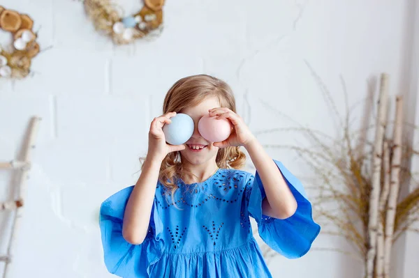 stock image Portrait of lovely, cheerful blond girl , holding colored eggs, celebrating Easter with family