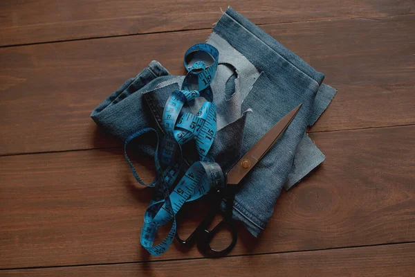 Denim Upcycling Ideas, Using Old Jeans, Repurposing Jeans, Reusing Old Jeans, Upcycle Stuff. Stack of old blue jeans and sewing tools