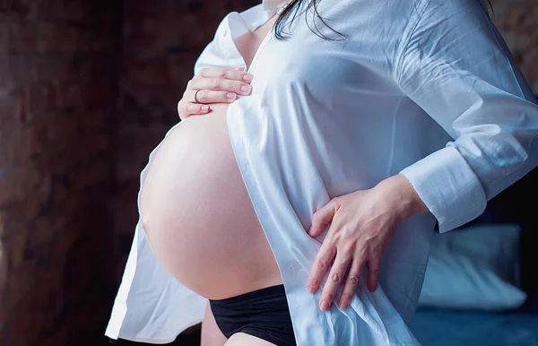 孕妇紧紧抓住她的腹部 怀孕的美丽照片 妈妈在等孩子妇女为生育做准备 产前时期概念 产妇保健 — 图库照片