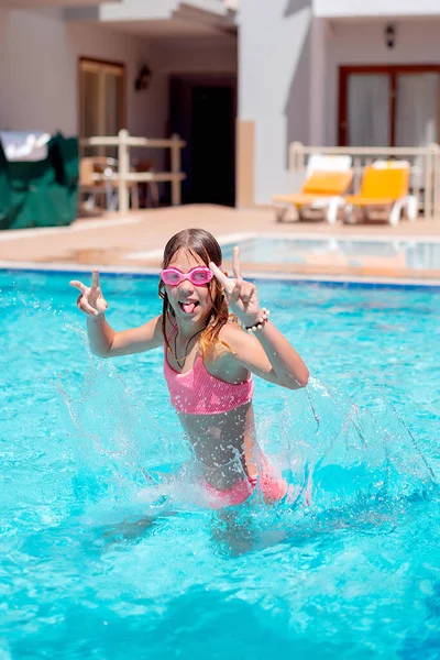 Teenage girl jumping in pool