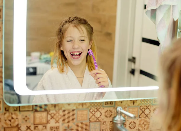 dental hygiene. happy little girl brushing her teeth. Morning routine.