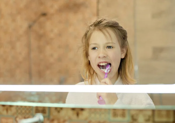 dental hygiene. happy little girl brushing her teeth. Morning routine.