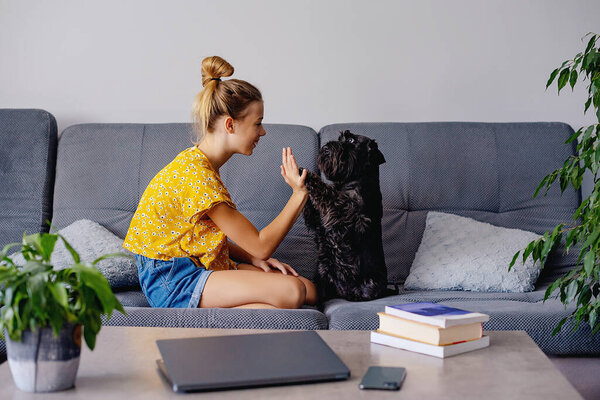 Digital detox concept. girl playing with dog at home.