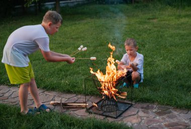 İki çocuk lokum kızartıyor.