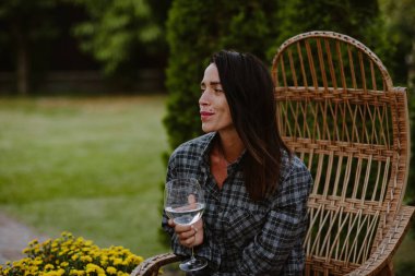 Sonbahar akşamında şarap içen çekici bir esmer.