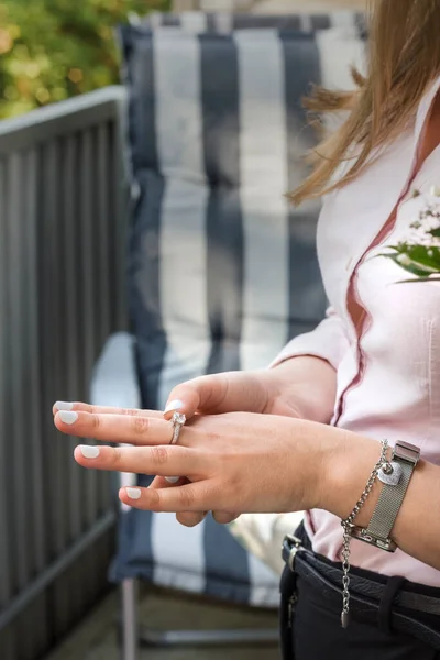 Hand of a young woman with a nice ring. Engagement. The scene on the balcony. Vertical image.