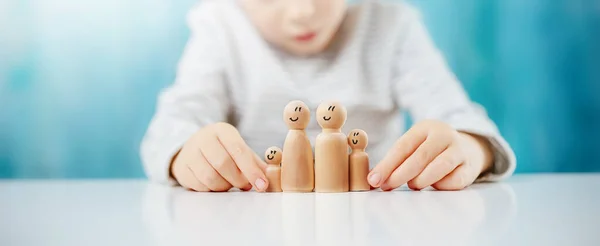 Child Sitting Table Wooden Figures Family Concept Love Safety Relation — Stock Photo, Image