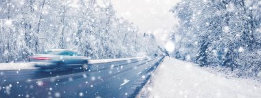 Cars on a road in snowfall rushing past on their own business. Beautiful background. clipart