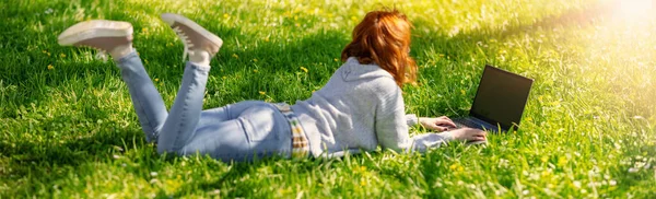 Woman Lying Laptop Blossoming Meadow Natural Park Panoramic Background 图库图片