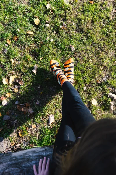 A girl in the garden with funny halloween socks. . High quality photo