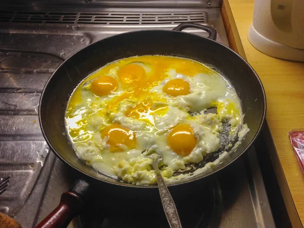 Cooking eggs in pan for breakfast. High quality photo