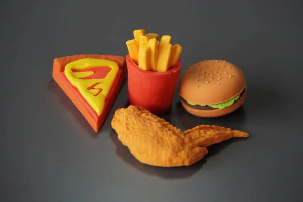 Closeup image of junk foods like burger, fries and pizza. Bad eating habits concept.