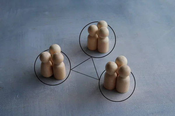 Groups of people are connected by lines. Interacting and joining forces with other teams. Interdependence correlation in workflow.
