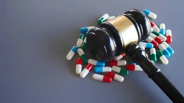 Judge gavel and pills with copy space. Medical law and drug law concept