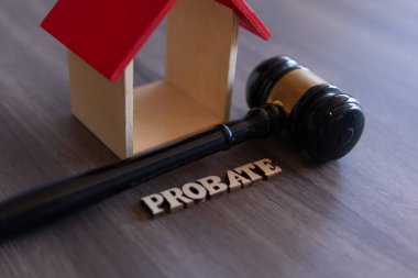 Closeup image of judge gavel, wooden house and word PROBATE. Copy space for text. clipart