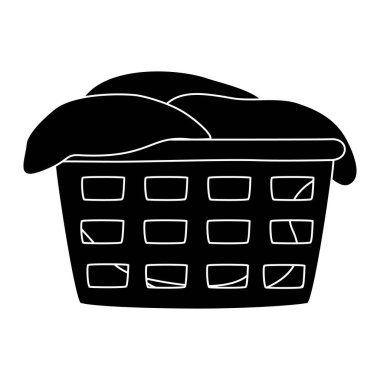 Çamaşır sepetinin siyah silueti yıkanmayı bekleyen kıyafetlerle dolup taşıyor.