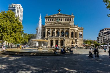 Frankfurt, Germany - 30th September 2022: Photographer visiting Frankfurt, exploring the old opera and its surroundings at a cold but sunny day in Autumn.