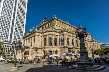 Frankfurt, Germany - 30th September 2022: Photographer visiting Frankfurt, exploring the old opera and its surroundings at a cold but sunny day in Autumn.
