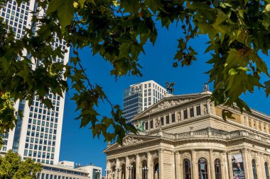 Frankfurt, Germany - 30th September 2022: Photographer visiting Frankfurt, exploring the old opera and its surroundings at a cold but sunny day in Autumn.