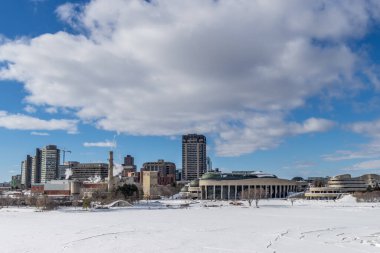 Having a walk through the Majors Hill Park in downtown Ottawa Canada with view to the historical buildings of the Canadian parliament and its surroundings at a cold but sunny day in winter.