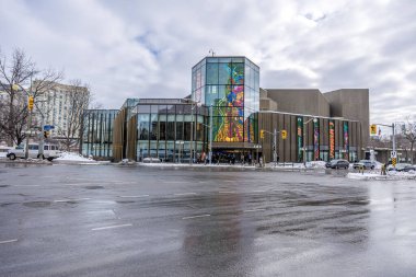 Ottawa, Canada - February 08th 2023: A german photographer discovering Majors Hill Park in downtown Ottawa with view to the Ottawa art gallery.