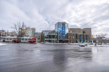Ottawa, Canada - February 08th 2023: A german photographer discovering Majors Hill Park in downtown Ottawa with view to the Ottawa art gallery.