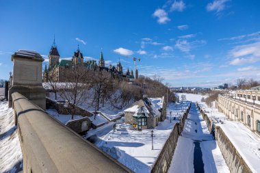 Ottawa, Canada - February 08th 2023: A german photographer discovering Majors Hill Park in downtown Ottawa with view to the historical buildings.