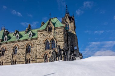 Ottawa, Canada - February 08th 2023: A german photographer discovering Majors Hill Park in downtown Ottawa with view to the historical buildings.