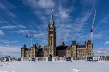 Ottawa, Canada - February 08th 2023: A german photographer discovering Majors Hill Park in downtown Ottawa with view to the historical buildings.