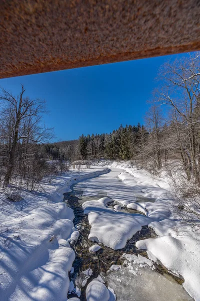 A creek in a winter wonder land not far away from Ottawa, Ontario in Canada at a cold but sunny day in winter.
