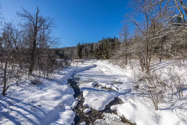 A creek in a winter wonder land not far away from Ottawa, Ontario in Canada at a cold but sunny day in winter.