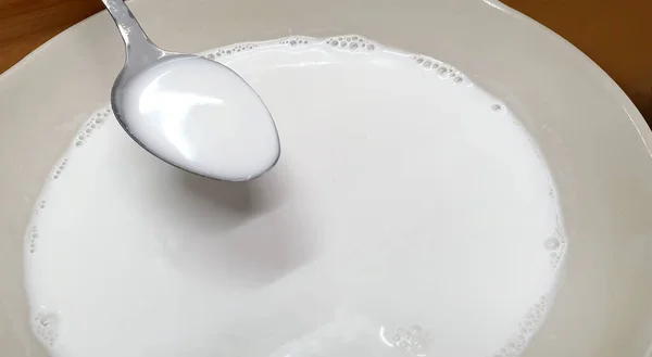 Top View Spoon Filled Coconut Milk White Bowl Preparate Cooking — Φωτογραφία Αρχείου
