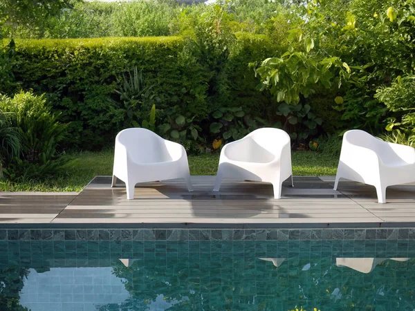 Modern Design White Plastic Chairs Swimming Pool Side Outdoor Garden Royalty Free Stock Photos