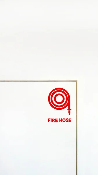 Logo symbol of Fire host reel icon on the Fire host cabinet door, red sign on white background, pictograms, real on construction site, fire protection system, hydrant, fire fighting