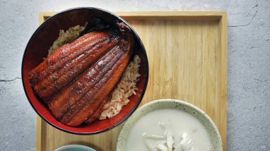 Unadon, ızgara tatlı su yılan balığı Unagi kabayaki, pirinç üzeri teriyaki sosu, geleneksel Japon mutfağı, ahşap urushi lacquerware 'de ızgara yılan balığı ve pirinç.