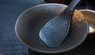 Close up Japanese eating utensils for lunch set including black bowl and rice paddle serving for individual on lunch or dining table clipart