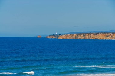 A view of a lighthouse on a clear sunny day along the Great Ocean Road in southern Victoria, Australia. clipart