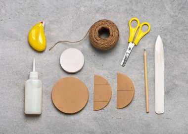 Kahverengi ve beyaz kafe filtreleri, yapıştırıcı, makas, kalem, jüt sicim, bal peteği topu yapmak için kemik klasörü olan el sanatları işyeri manzarası. Üst görünüm. 