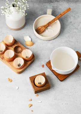 Melt the wax. Natural craft for kids concept. Making trendy DIY candles for Easter from eggshells. Copy space.