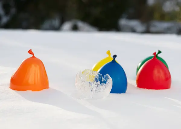 stock image Draining the water and peeling away the remaining balloon. Making Ice vases with latex balloons and water in frosty winter day. Easy fun kids crafts concept. Step 2